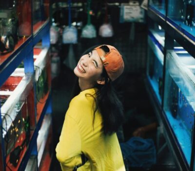 photo-of-smiling-woman-in-yellow-top-and-orange-hat-posing-3208616-scaled-min